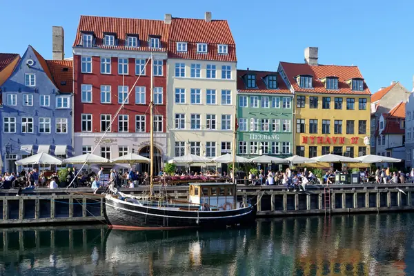 Colourful townhouses and moored wooden boats along the Nyhavn canal, Copenhagen