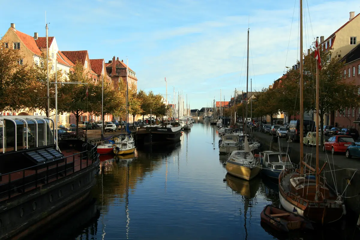 Moored boats and old townhouses along Christianshavns Kanal, Copenhagen, in morning light