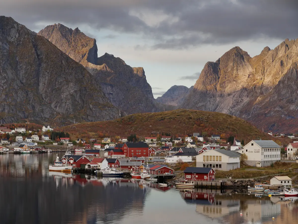 The fishing village of Reine beneath steep mountain peaks in Lofoten, Norway