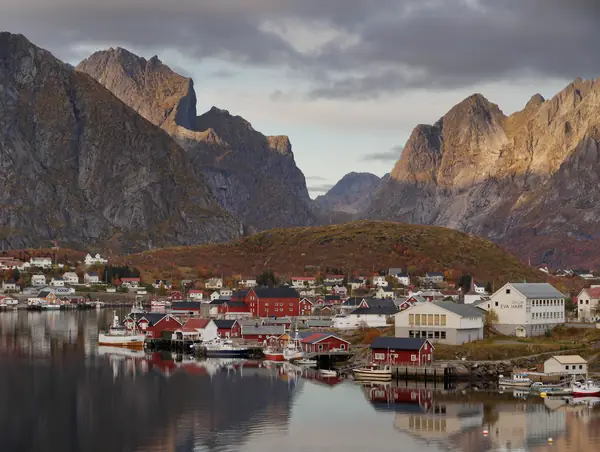The fishing village of Reine beneath steep mountain peaks in Lofoten, Norway