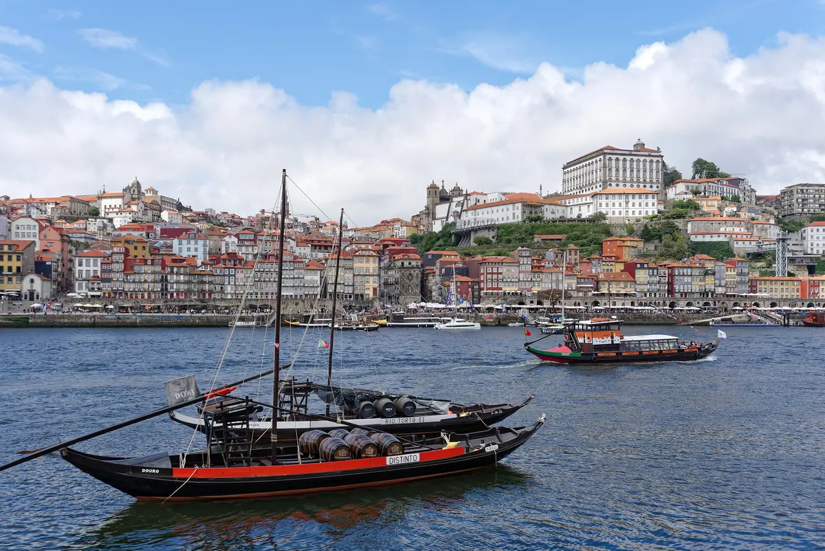 Traditional rabelo boats on the Douro river, with Porto's Ribeira district behind, Portugal