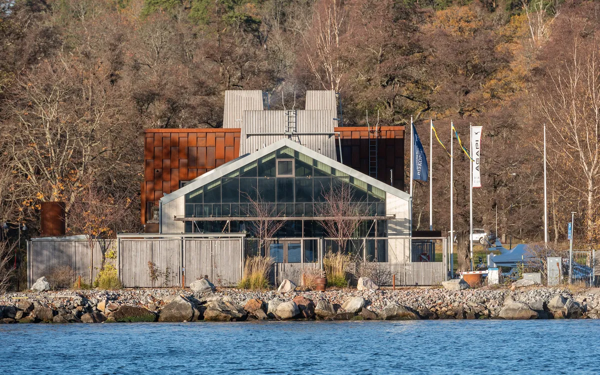 Aira's glass, concrete and rusted-metal building beside the water in Stockholm (photographed in 2024)