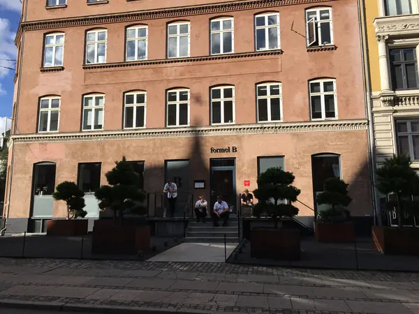Formel B's red-brick corner building with planters out front, Copenhagen, 2019